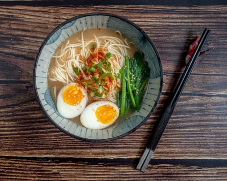 A bowl of ramen with chopsticks on the side