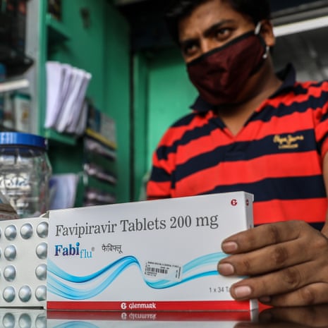 A chemist displays the Fabiflu tablets at his store in Mumbai, India, on 23 June
