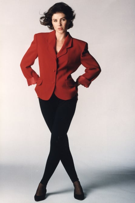 Sadie Frost modelling in 1992, wearing black leggings, pumps and a red jacket