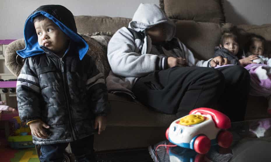 Eithan Colindres and his family wear winter coats indoors after power cuts in Houston, Texas.