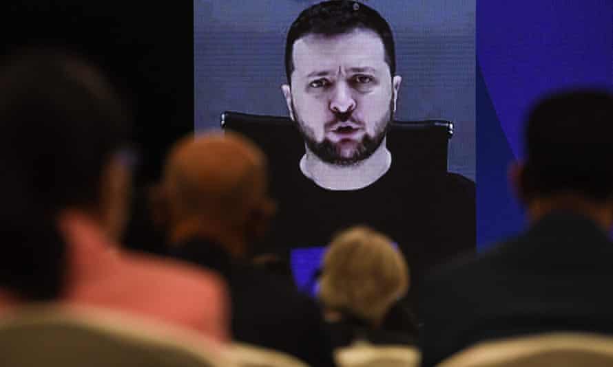 Ukraine’s President Volodymyr Zelenskiy (on screen) addresses participants at the Shangri-La Dialogue summit virtually via a video link in Singapore.