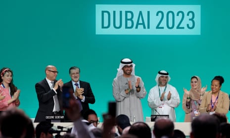 Cop28 president Sultan Ahmed Al Jaber (C) applauds among other officials before a plenary session during the United Nations climate summit in Dubai on 13 December  2023