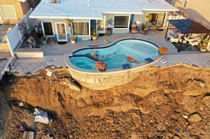 San Clemente, California. An aerial view of a pool at the edge of a hillside landslide brought on by heavy rain