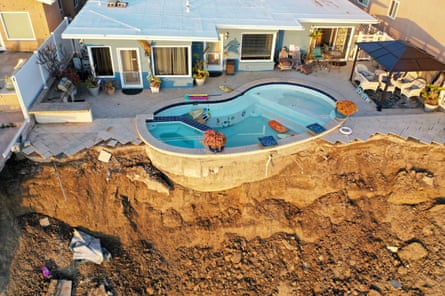 A house is left hanging from a cliff after a landslide in Orange county, California.