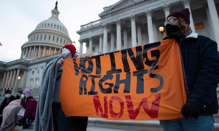 Activists hold a sign that reads 'Voting Rights Now', at the steps of Capitol Hill on Wednesday.
