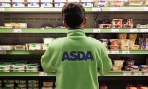 Young employee filling the shelves at Asda supermarket
