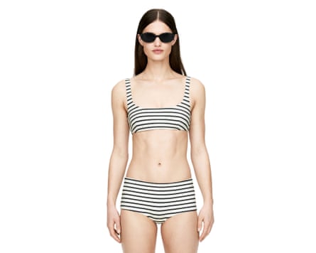 A model wears an Arket Bikini Hipsters and Bikini Top. Both are white and black horizontol stripes.