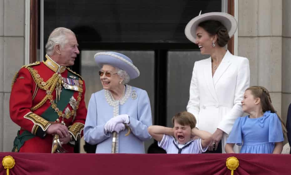 Britain's Prince Charles, left, with Queen Elizabeth II, Prince Louis her great-grandson, covering his ears with his hands, next to his mother Kate Duchess of Cambridge and Princess Charlotte her daughter, at right, stand on the balcony of Buckingham Palace,