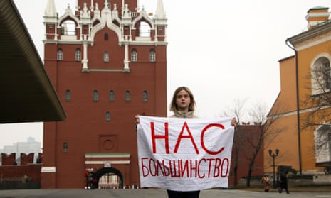 An activist holds a sign that reads ‘We are the majority’ in a protest outside the Kremlin on International Women’s Day. 