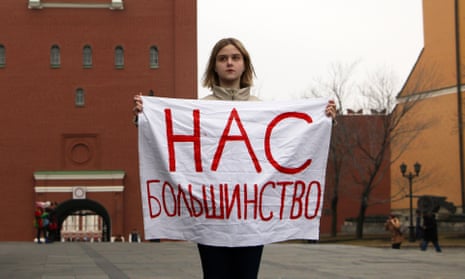 An activist holds a sign reading ‘We are the majority’ outside the Kremlin on International Women’s Day.