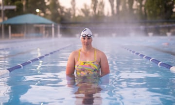 Swimmer Peta Bradley in a pool in Armidale as mist rises on the water behind her