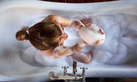 Woman playing with foam in a bathtub