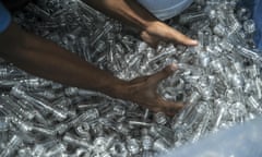 An employee handles plastic bottles at a facility