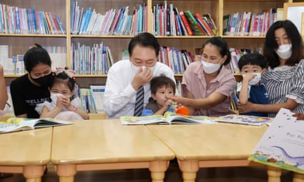 The South Korea president, Yoon Suk-yeol (centre) at a daycare centre in Seoul, South Korea in August.