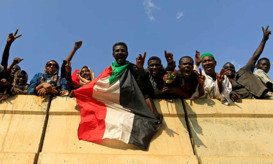 Khartoum: civilians hold their national flag as they celebrate the signing of the Sudan’s power sharing deal.