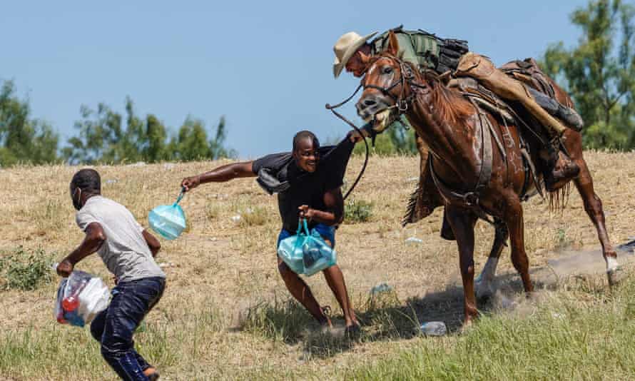 A now-iconic photo of a US border patrol agent on horseback trying to stop a Haitian migrant from entering an encampment in Del Rio, Texas, on 19 Sept 2021.