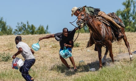A now-iconic photo of a US border patrol agent on horseback trying to stop a Haitian migrant from entering an encampment in Del Rio, Texas, on 19 Sept 2021.