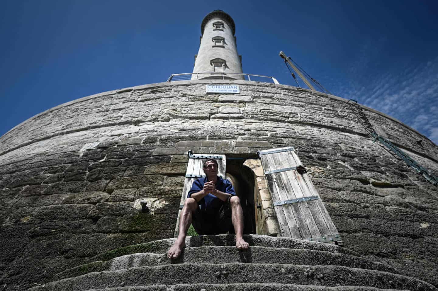 Dalisson sits outside lighthouse