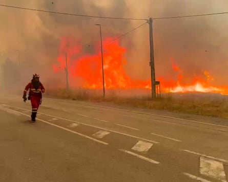 Firefighters tackling a wildfifre near Yeres, north-western Spain