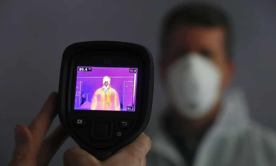 An infrared camera scans a person for elevated body temperature