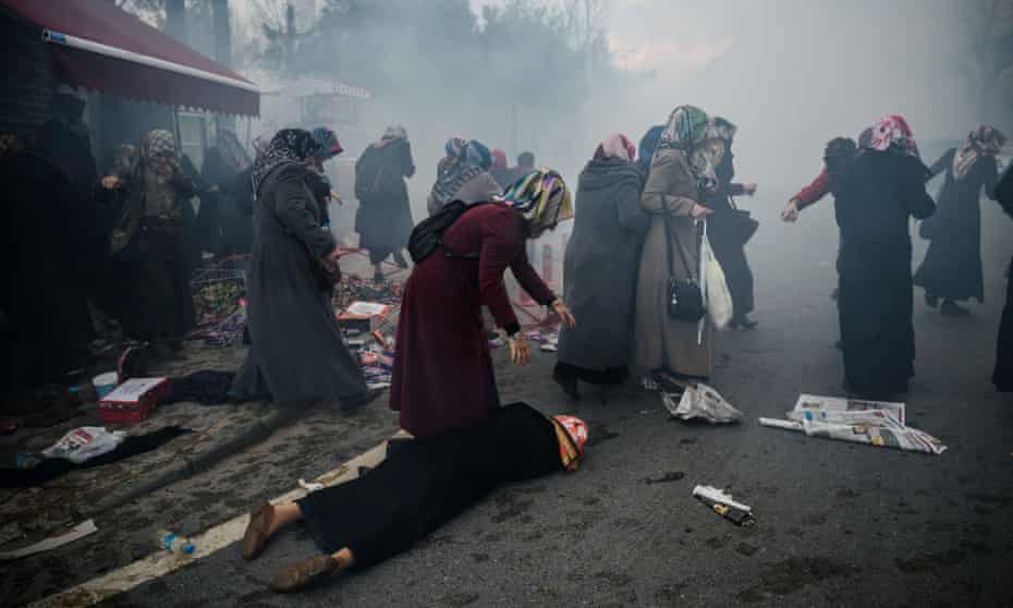 Women protesting against the seizure of the offices of the Zaman newspaper in Istanbul being dispersed by teargas