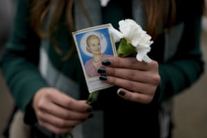 A woman holds a photo of Perón as she waits her turn to visit the former first lady’s tomb