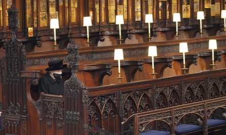 The Queen sits alone in St George’s chapel