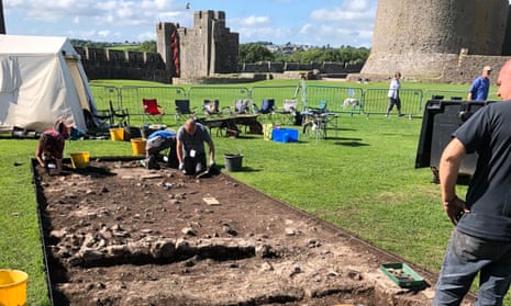 Archaeologists uncovering walls of a late medieval house in the grounds of Pembroke Castle.