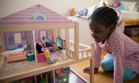 Child playing with her dollhouse.