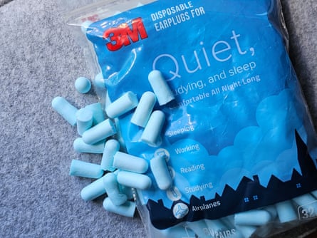 A bag of light blue 3M Quiet earplugs sitting on fabric surface
