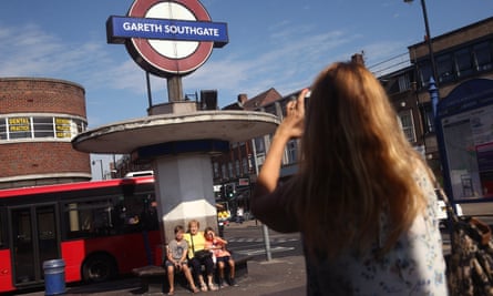 People pose for pictures outside Gareth Southgate station