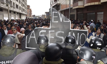 People holding at a sign reading ‘Evo assassin’ at a demonstration in El Alto on 17 February 2016