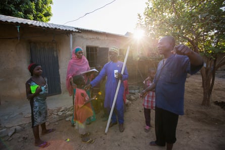 Community-directed distributors Danladi Ishaku and Baraka Ango administer preventive treatment