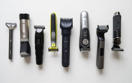 Eight beard trimmers lined up in a row on a white worktop