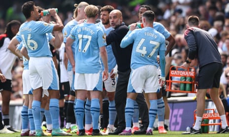 Pep Guardiola talks to his squad during Manchester City’s win over Fulham