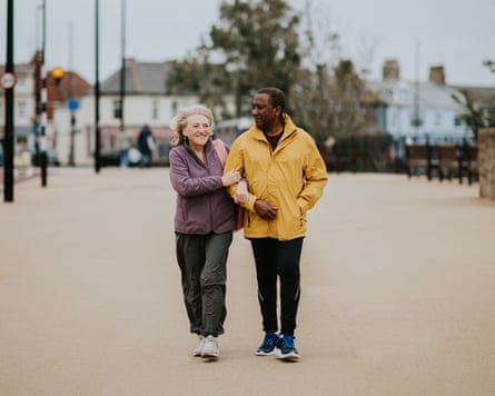 Two people walking arm in arm