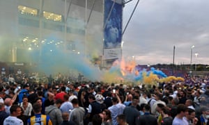 Leeds United supporters gather outside their Elland Road ground to celebrate the club’s return to the Premier League after a gap of 16 years