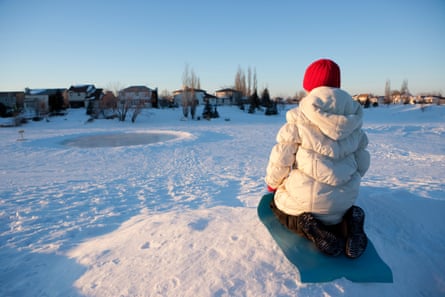 Girl sledingYoung girl getting ready to sled down the hill in Winnipeg, Manitoba.
