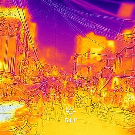 A thermal image shows a purple sky, red and yellow buildings and the outline of people and market stalls