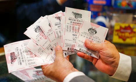 A customer holding Mega Millions lottery tickets.