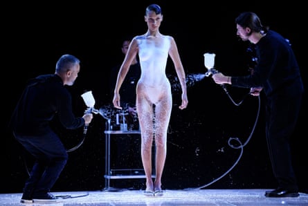 Bella Hadid is dressed by spraying Fabrican connected  to her body