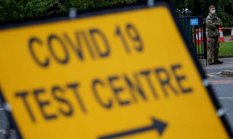 A soldier stands near a sign at the entrance of a testing centre in Blackburn