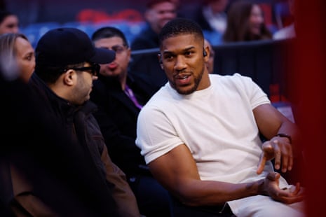 Anthony Joshua talks to Turki al-Sheikh at ringside.