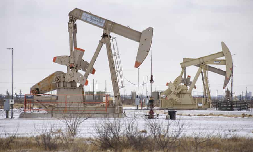 Pumpjacks operate in a snowy oil patch in Midland, Texas.