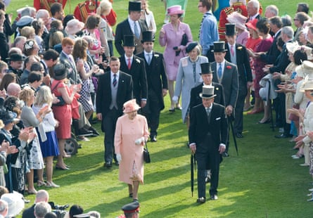 Queen Elizabeth II and Prince Philip meet guests at a Buckingham Palace garden party in 2012