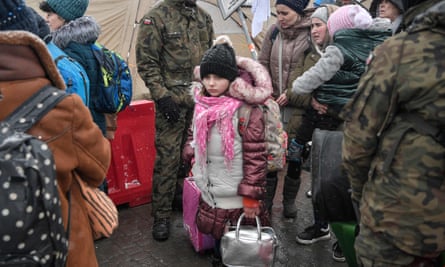 Newly arrived refugees seek assistance from Polish army soldiers after crossing the border from Ukraine into Poland at the Medyka border crossing, eastern Poland, 9 March