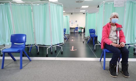 Woman waits in vaccination centre in Llanelli, south Wales