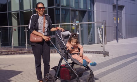 Woman with a child in a pushchair.