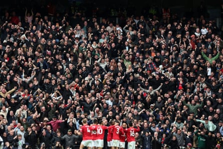 Bryan Mbeumo of Manchester United (obscured) celebrates with teammates.