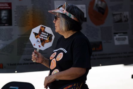 A woman uses a fan to cool herself off during a demonstration against poor conditions caused by extreme heat in Texas jail cells.